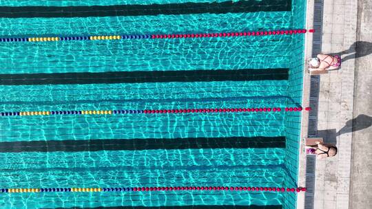 美女运动员跳入露天游泳馆水池训练专业航拍