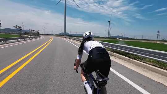 航拍美女公路骑自行车骑行风车蓝天白云视频素材模板下载
