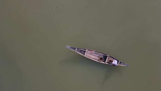 在伊查马蒂河上漂浮的传统木船上俯瞰孤独渔夫