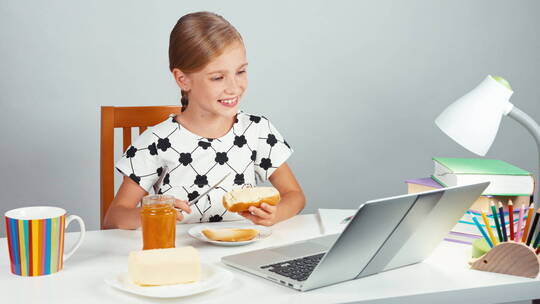 女孩用刀子把果酱抹在面包上视频素材模板下载
