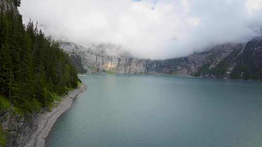 空中飞行在瀑布旁边的山景，无人机在蓝湖上