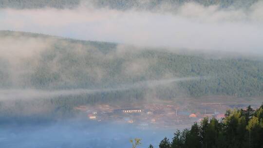 山坳里晨雾中的山村