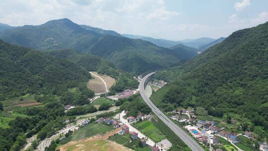 航拍大山中的高速公路高铁轨道