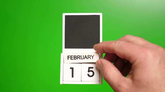 02.绿色背景上日期为2月15日的日历。