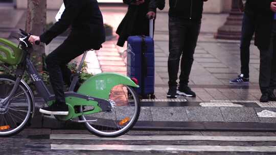 一个男人在城市街道上骑绿色自行车