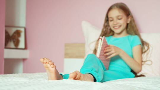 女生坐在床上看书
