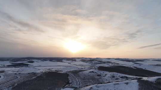 航拍丘陵山地雪景晚霞延时