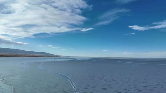 青海青海湖蓝天白云湖面结冰航拍4K视频