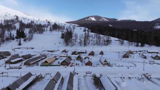 航拍新疆冬季喀纳斯湖雪景森林雪山下的村落