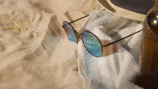 沙滩上的太阳镜和毛巾特写