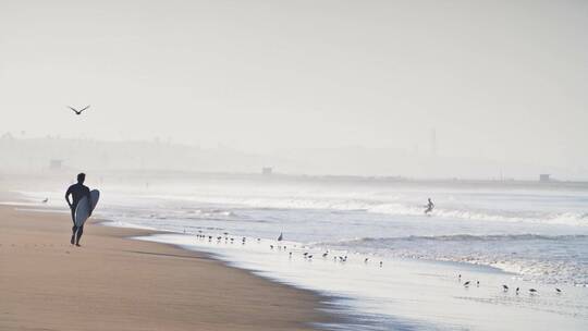 冲浪者沿着海滩奔跑视频素材模板下载