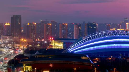 城市落日晚霞日转夜灯光五里河体育场体育馆视频素材模板下载