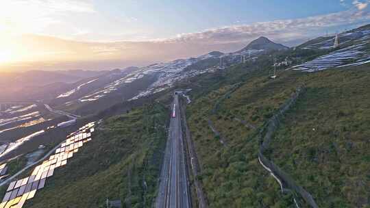 航拍高铁穿越山地光伏场