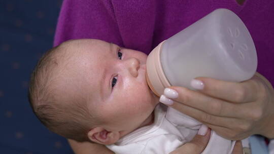 宝妈给刚出生的婴儿喂奶喝奶粉