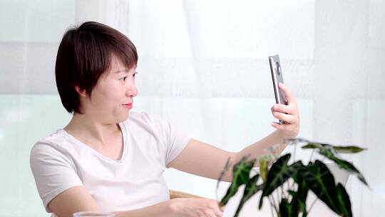 在家使用手机自拍的亚洲年轻女性
