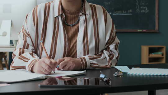 穆斯林女学生在英语课堂课桌上做笔记的肖像