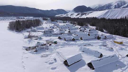 航拍新疆禾木雪景森林雪地小木屋禾木桥雪山