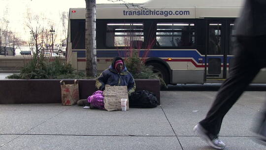 女人蹲坐在芝加哥大街上求助