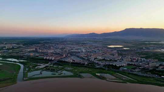 航拍夕阳下宁夏石嘴山惠农区城市风光