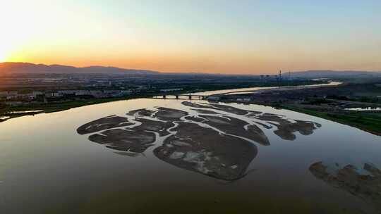 航拍宁夏石嘴山夕阳下的黄河湿地石嘴子公园视频素材模板下载