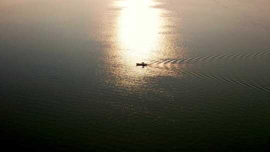 夕阳下平静海面上的渔船