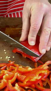 厨师用锋利的刀把甜椒切成砧板上的碎片