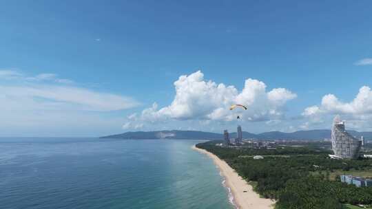 航拍三亚海棠湾蓝天白云动力伞直升机海岸线视频素材模板下载