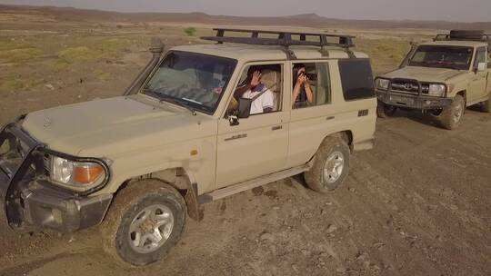 空中拍摄两辆沙漠中的吉普车视频素材模板下载