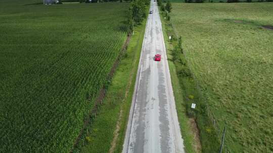 航拍汽车行驶在田地的道路上