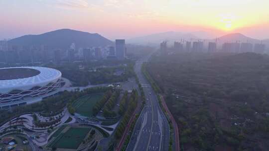 航拍枣庄城市晨雾中的文体活动中心双子星