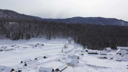 航拍新疆禾木雪景森林雪地小木屋禾木桥雪山