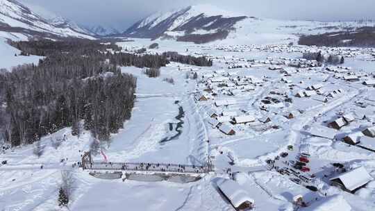 航拍新疆禾木雪景森林雪地小木屋禾木桥雪山