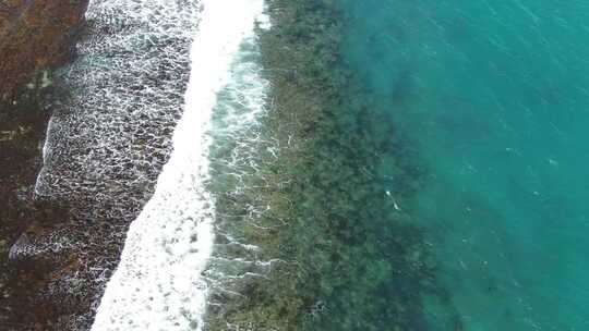 航拍海岸边的海浪拍打岸边