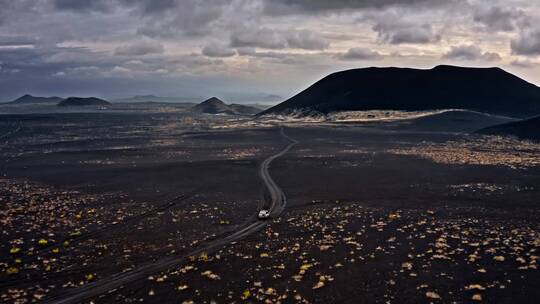 吉普车行驶在火山附近的路上