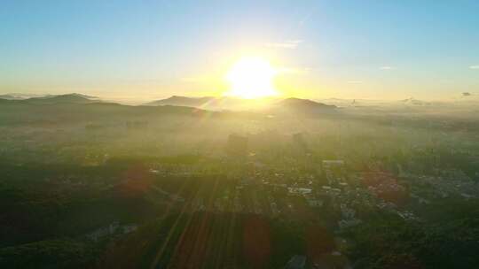 航拍广州白云山日出时分城市与山峦景色