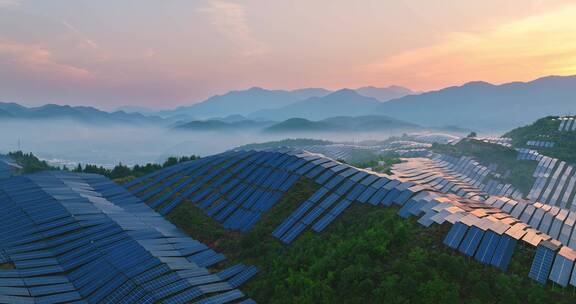 新能源太阳能光伏发电站夕阳下山坡航拍