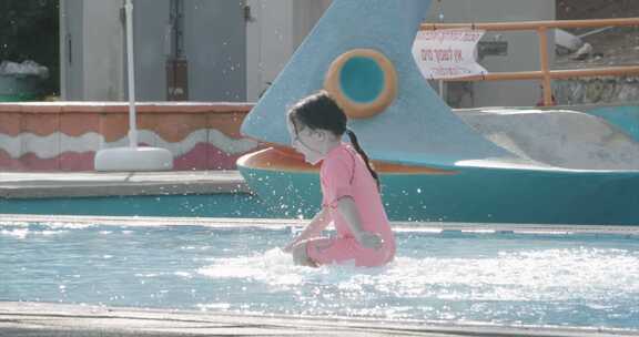 年轻女孩在游泳池里向前潜入水中