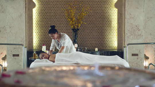 女人在豪华温泉酒店享受放松按摩spa