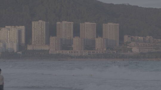 夕阳海岸城市沙滩海浪