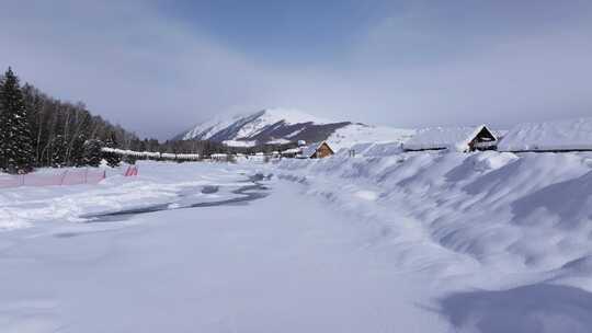 航拍新疆禾木雪景森林雪地小木屋禾木桥雪山