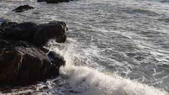 青岛海滨海浪冲刷岩石浪花飞溅