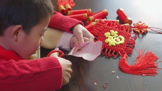 亚洲中国母子春节剪纸剪窗花红纸