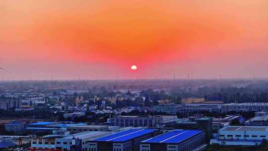 航拍平原夕阳落日房屋风力发电晚霞鸟类