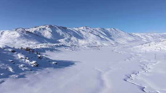 航拍新疆阿勒泰喀纳斯雪景白雪覆盖的雪山