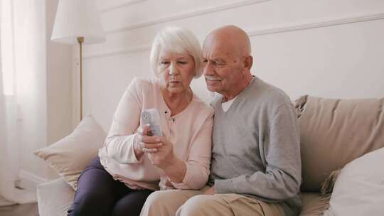 使用温度枪的老年夫妇