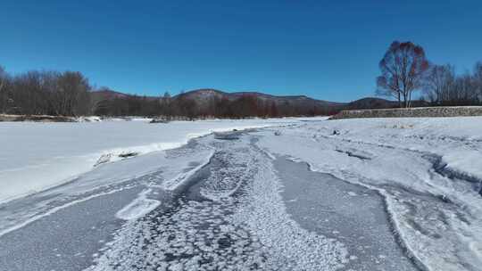 航拍初春库都尔河开河雪景