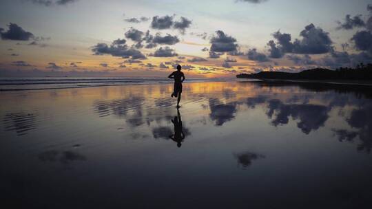 夕阳下在海边水面慢跑