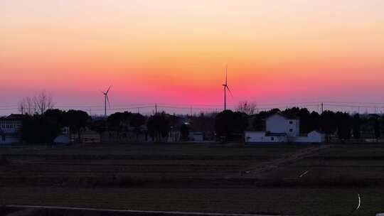 航拍田野农村民房别墅风力发电夕阳池塘