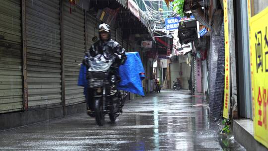 下雨天巷子街道行人电动车