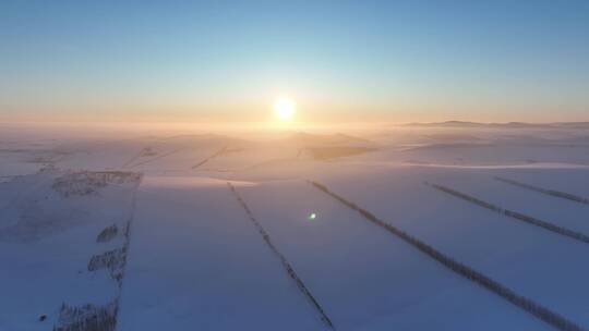 航拍丘陵雪原日落夕阳